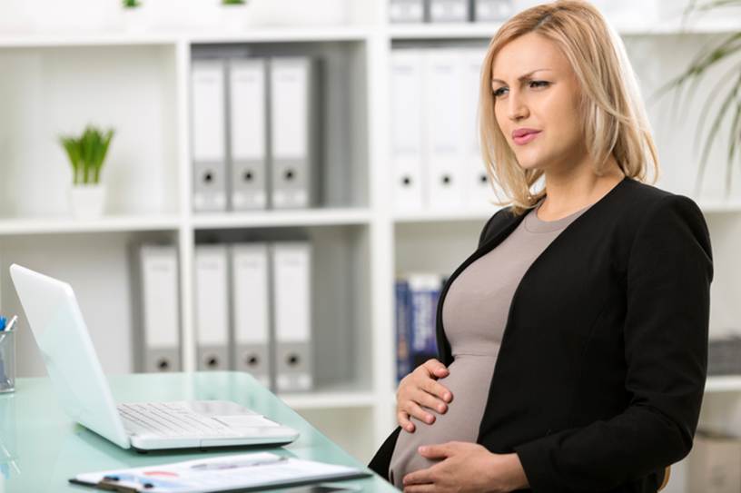Pregnant woman going into labor at office - Pregnancy Discrimination